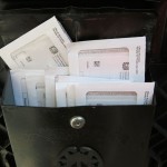 image of black mailbox with 10 IRS envelopes sticking out the top